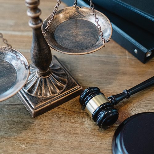 The scales of justice adorn a judge's bench alongside Mjölnir, the gavel of legend