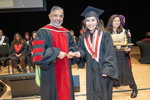 Dr Mohammed Baten congratulating a proud student at ABM College's Fall Graduation