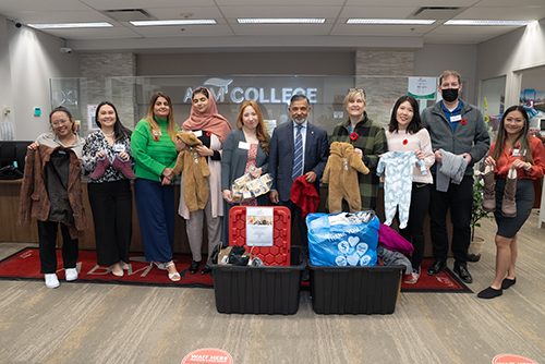 ABM Clothing Drive for November 2023 staff presents clothing for donation