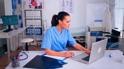 Medical office assistant while working on some files