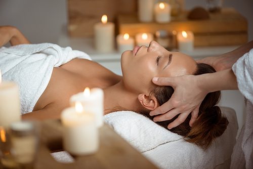 A female patient lies on the massage table as her RMT releases her tension