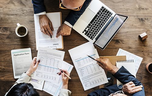 A board meeting with accountants reviewing projections with management