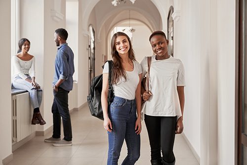 A pair of female students read to head to their practicum for onsite training