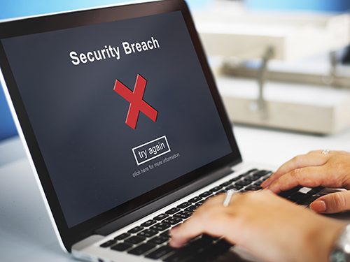 A laptop displaying a security breach when the user tries to access their information