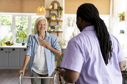 A Personal Support Worker visits his elderly client with limited mobility