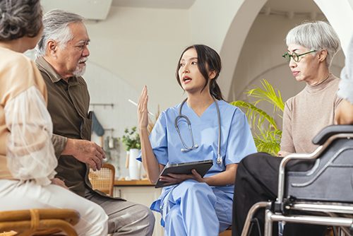 A young nurse meets with a group of seniors to discuss health issues