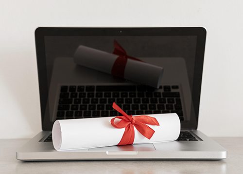 A diploma on a laptop, the result and tool of online learning