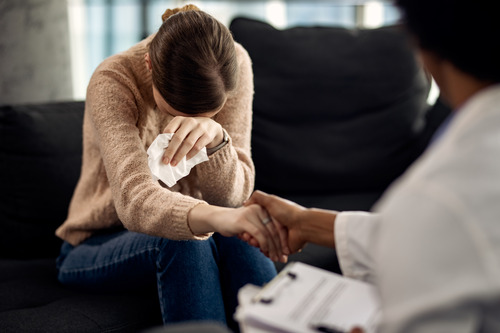 Girl sitting with doctor and crying with full of emotions 