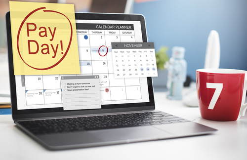 Laptop calendar planner for business emphasizing payday