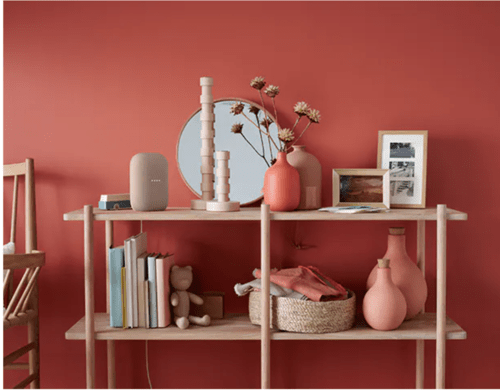 A google home nest on bookshelf