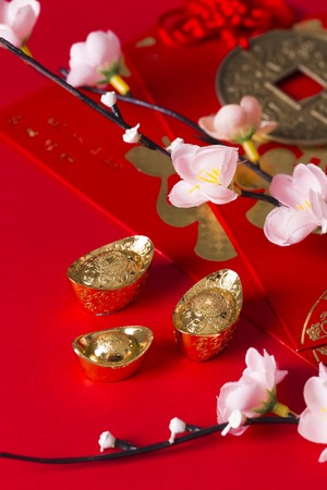 Beautiful Chinese New Year concept art with red envelopes flowers gold coin and gold ingots