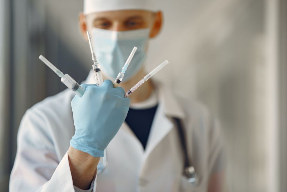 Doctor holding a set of syringes