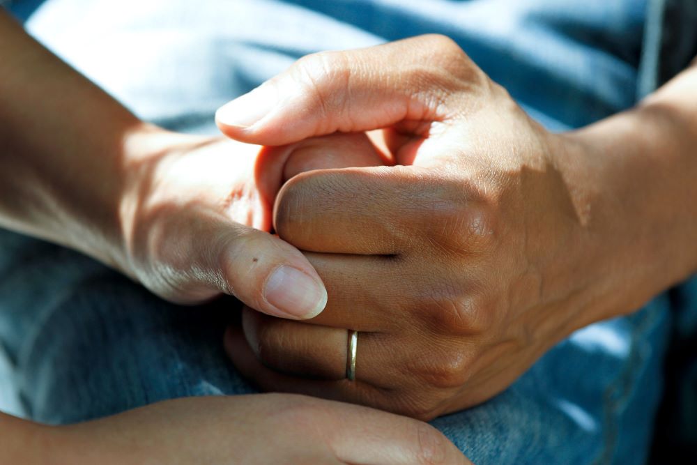 Support worker holding hand of the patient