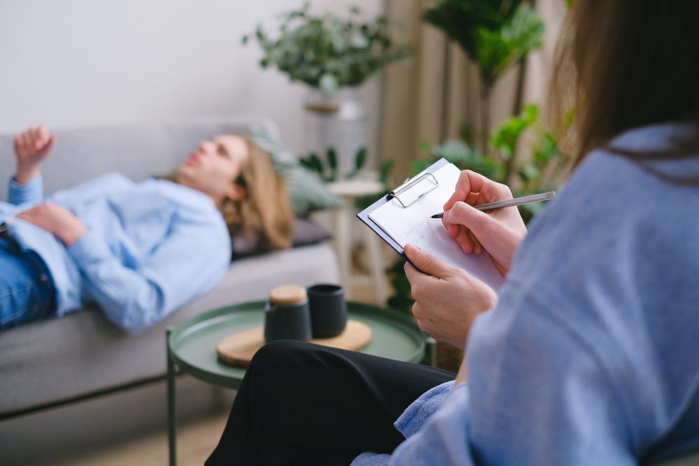 Support worker taking notes on patient's behavior